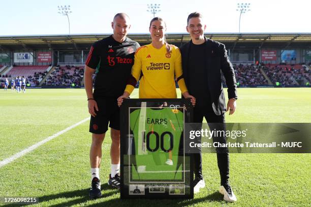 Mary Earps of Manchester United receives an award for 100 appearances from Manchester United Head Coach / Manager Marc Skinner & Ian Willcock prior...