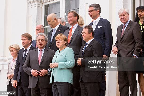 German Chancellor Angela Merkel poses for a group photo with German Minister of Work and Social Issues Ursula von der Leyen , Roland Pofalla ,...