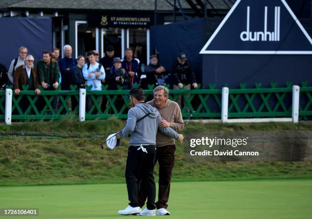 Johann Rupert of South Africa The CEO and Chairman of The Richemont Group embraces his professional playing partner Louis Oosthuizen of South Africa...