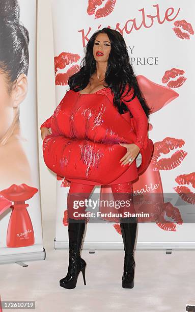 Katie Price attends a photocall to launch her new fragrance 'Kissable' at The Worx Studio's on July 4, 2013 in London, England.