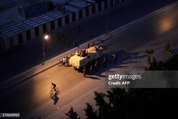 An Egyptian army Armored Personnel Carrier and soldiers are stationed on a street in Cairo following the toppling of ousted Egyptian president...