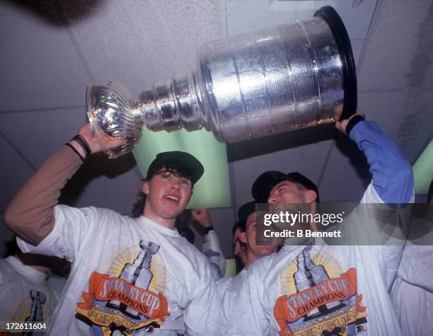 Jaromir Jagr and Jiri Hrdina of the Pittsburgh Penguins hold the Stanley Cup in the locker room after Game 6 of the 1991 Stanley Cup Finals against...