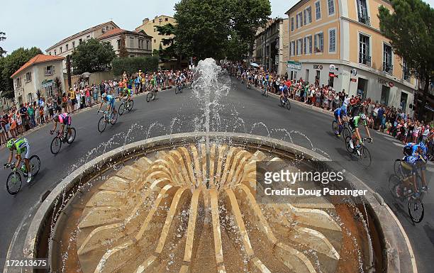 The breakaway passes a fountain in the Place Roger Le Roux during stage five of the 2013 Tour de France, a 228.5KM road stage from Cagnes-sur-mer to...