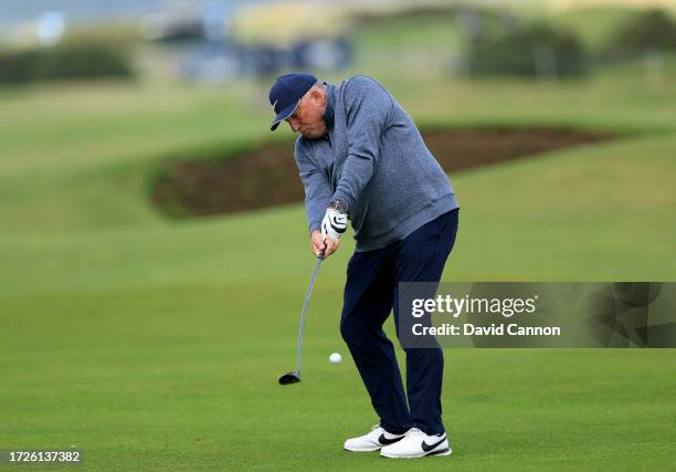 Sir Ian Botham of England the former cricketer plays his second shot on the 17th hole during round three on Day Five of the Alfred Dunhill Links...