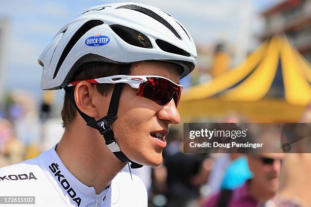 Michal Kwiatkowski of Poland rising for Omega Pharma-Quick Step wears the best young rider's white jersey as he prepares to start stage five of the...