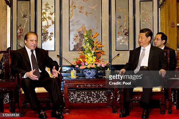 Pakistan Prime Minister Nawaz Sharif talks to Chinese President Xi Jinping during a meeting at the Diaoyutai State guest house July 4, 2013in...