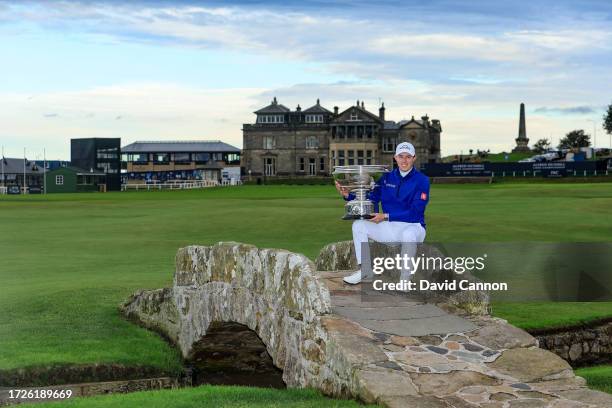 Matthew Fitzpatrick of England poses with the trophy on The Swilcan Bridge after the conclusion of round three on Day Five of the Alfred Dunhill...