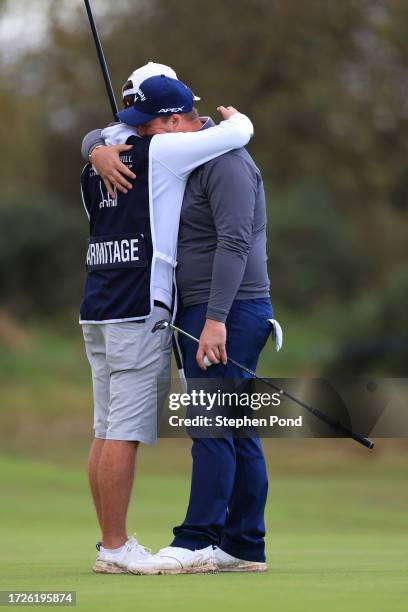 Marcus Armitage of England embraces his caddie after putting on the tenth green during Round Three on Day Five of the Alfred Dunhill Links...