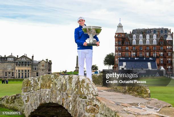 Matt Fitzpatrick of England poses with the trophy on the Swilcan Bridge following victory on Day Five of the Alfred Dunhill Links Championship at the...