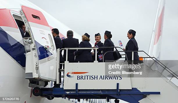 Cabin crew wait to enter the new Boeing Co. 787 Dreamliner aircraft operated by British Airways at Heathrow airport in London, U.K., on Thursday,...