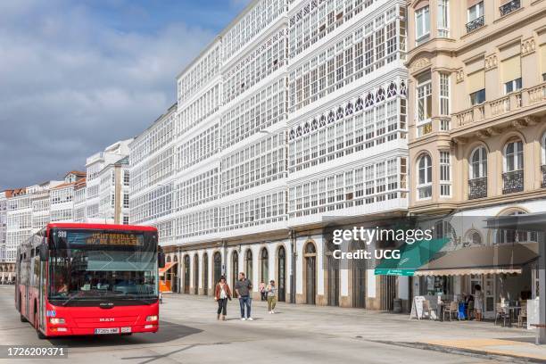 Glassed-in balconies typical of La Coruna known as gallerias on Avenida de Montoto. La Coruna, La Coruna Province, Galicia, Spain. Public transport.