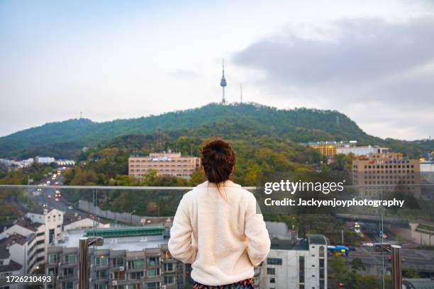 young asian woman travelling through seoul city and taking in the scenery - south korea skyline stock pictures, royalty-free photos & images