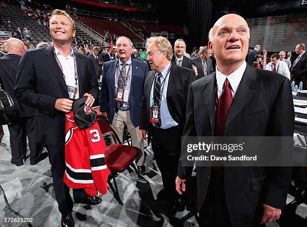 Goaltender Martin Brodeur of the New Jersey Devils and President and general manager Lou Lamoriello react after Martin announced his son Anthony...