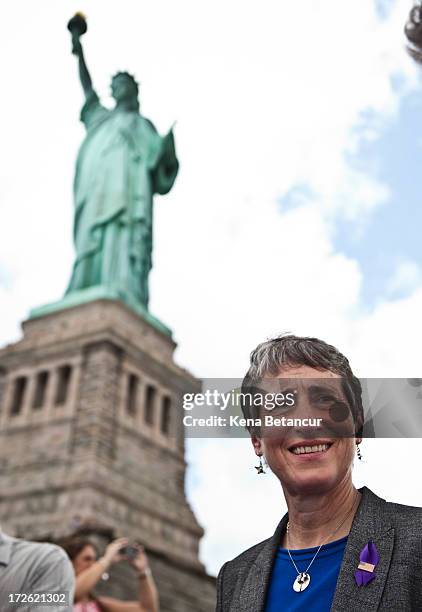 Secretary of the Interior Sally Jewell walks by the Statue of Liberty on the first day it is open to the public after Hurricane Sandy on July 4, 2013...