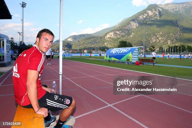 Mario Goetze of FC Bayern Muenchen watches the training session of his team mates at Campo Sportivo on July 4, 2013 in Arco, Italy.