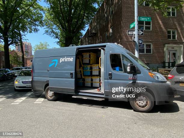 Amazon Prime delivery van unloading packages on street corner, Queens, New York.