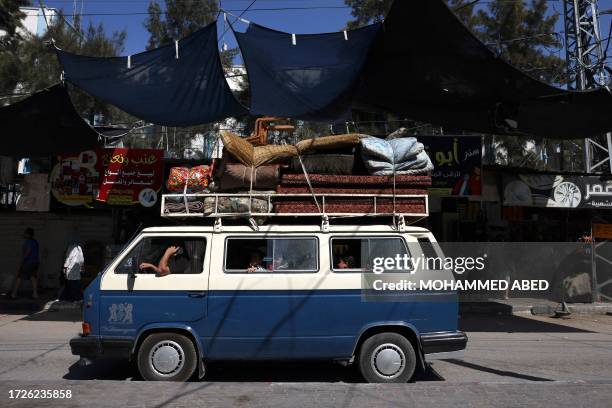 Palestinian van carrying a family and their belongings arrives at the Rafah refugee camp, in the southern of Gaza Strip on Octobers 15, 2023. Convoys...