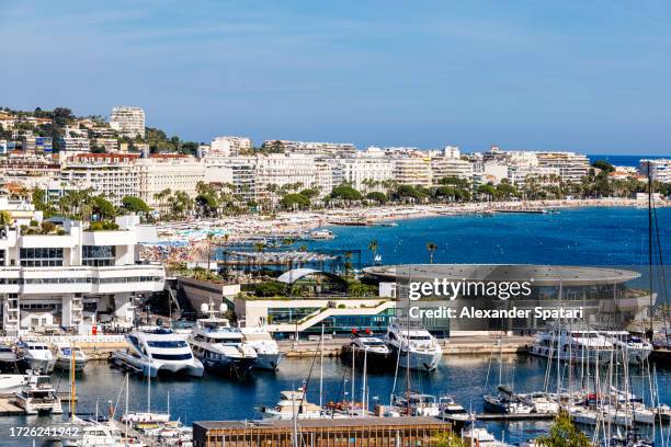 cannes cityscape with harbour with yachts and croisette beach, french riviera, france - the french riviera road stock-fotos und bilder