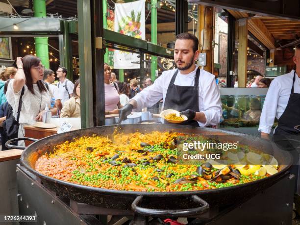 Spanish paella food stall at Borough Market, London, UK.