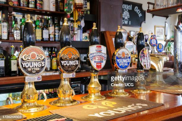 Row of traditional English bitter beer pumps in pub, England, UK.