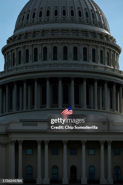 The U.S. Flag flies at half-staff over the U.S. Capitol as Congress remains stalled because there is no elected Speaker of the House and the Senate...