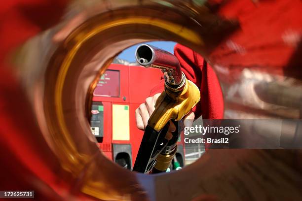 a person filling up the car in a gas station - biofuel stock pictures, royalty-free photos & images