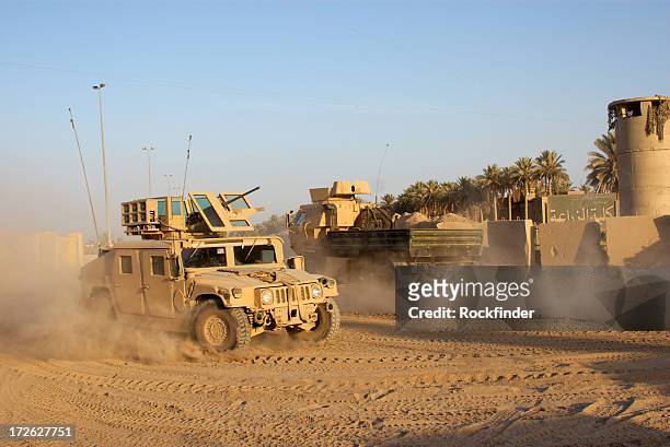 army car going to its base on a dirty road - iraq stock pictures, royalty-free photos & images