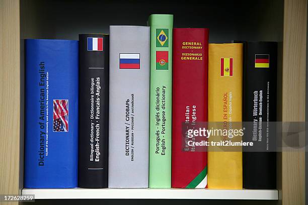bookcase with numerous foreign languages dictionaries. - english culture stock pictures, royalty-free photos & images