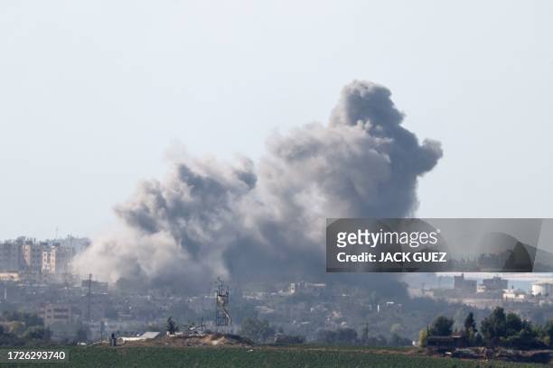 Picture taken from the southern Israeli side of the border with the Gaza Strip on October 15 shows smoke billowing after Israeli bombardment of an...