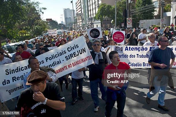 Civilian police officers take part in a demonstration against their low salaries and bad working conditions, in Sao Paulo, Brazil, on July 4, 2013....