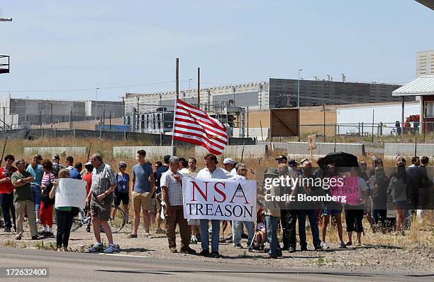 With the NSA Data Center in the background, protesters chant and sing songs at the entrance of the new National Security Agency data center facility...