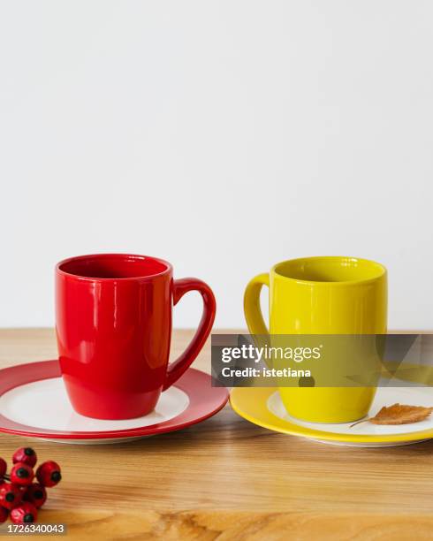 two empty cups arranged together on wood texture surface on white wall background - two mugs stock pictures, royalty-free photos & images
