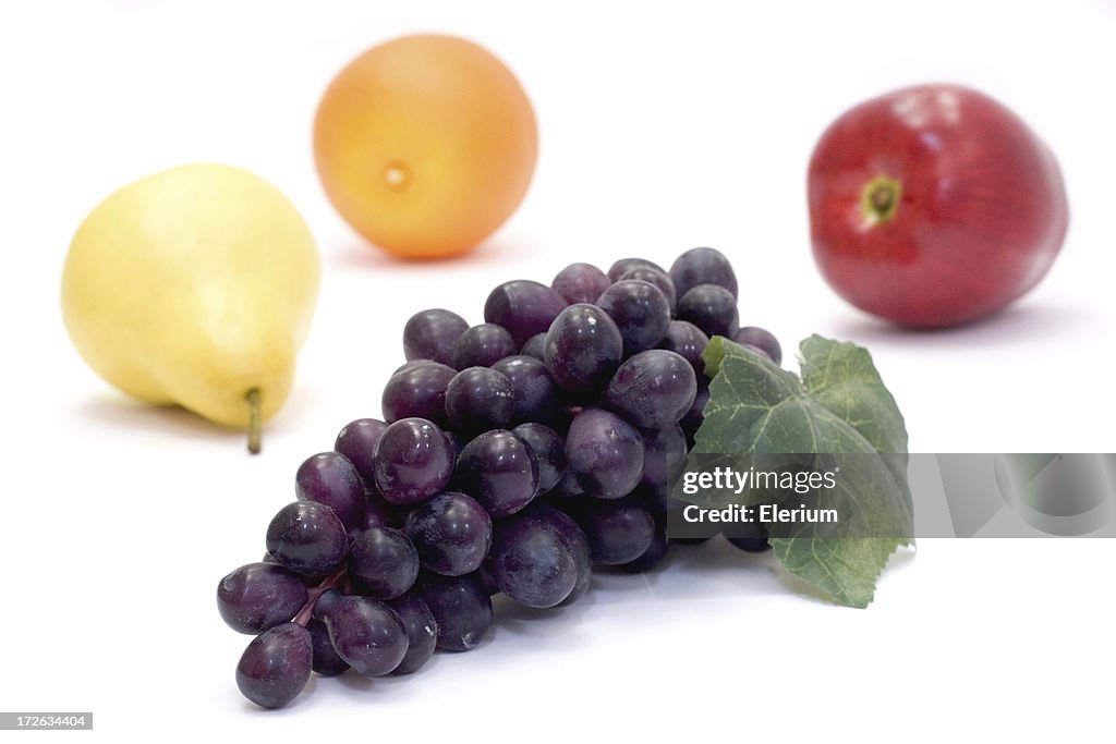 Grapes with a pear, orange and apple