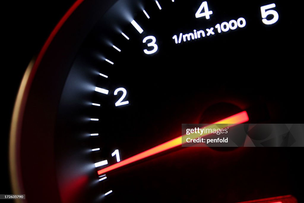 A lit up black dashboard with an orange arrow