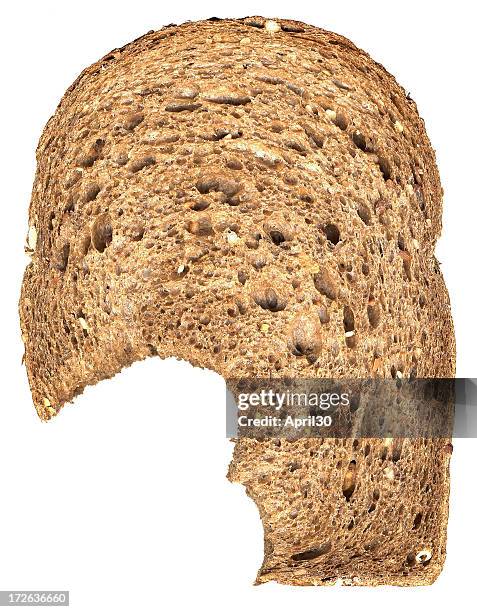 a bite taken out of a slice of bread - granary stock pictures, royalty-free photos & images