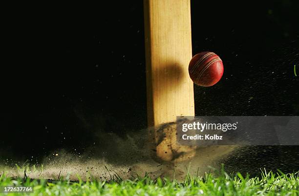 close-up shot of cricket bat hitting ball - cricketspeler stockfoto's en -beelden