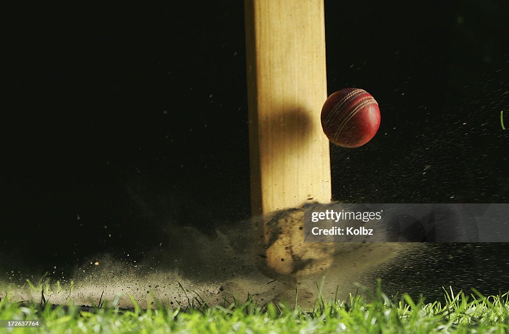 Close-up shot of cricket bat hitting ball