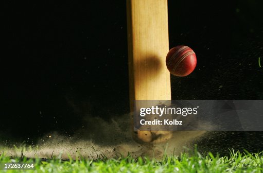 Close-up shot of cricket bat hitting ball Close-up shot of cricket bat hitting ball