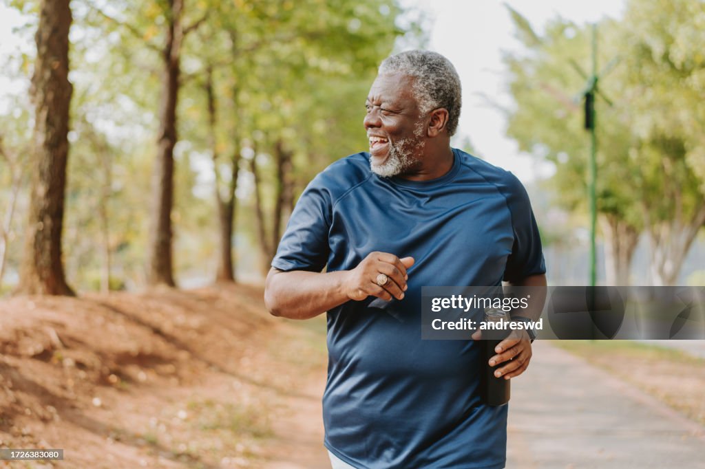 Senior man running in public park