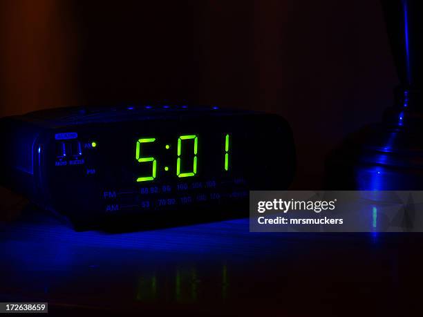 501 displayed on a clock in a dark room - alarm stockfoto's en -beelden