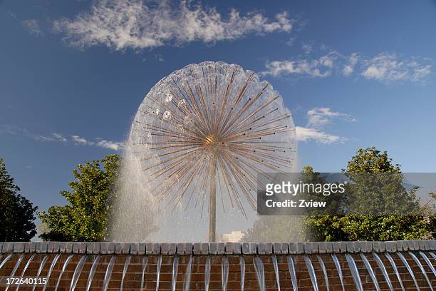 spraying spherical fountain in city park - houston texas stock pictures, royalty-free photos & images