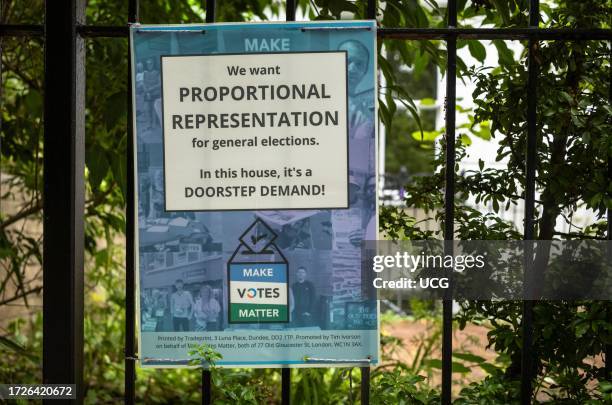 Poster attached to railings calling for the British general elections system to be changed to proportional representation. Winchester, Hampshire, UK.