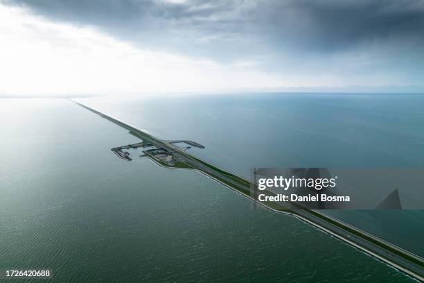 aerial photo a the afsluitdijk dike in the netherlands - dique barragem imagens e fotografias de stock