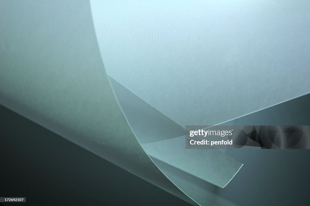 Graphic of curled edges of paper on gray