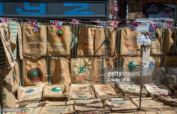 Used coffee sacks from around the world for sale in Brick Lane Market, London, UK.