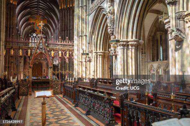 The ornate carved Choir Stalls behind the Choir Screen inside the ancient Lichfield Cathedral, Staffordshire, UK.