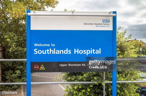 Large blue and white sign stating "Welcome to Southlands Hospital" at the main entrance to the NHS hospital in Shoreham-by-Sea, West Sussex, UK.