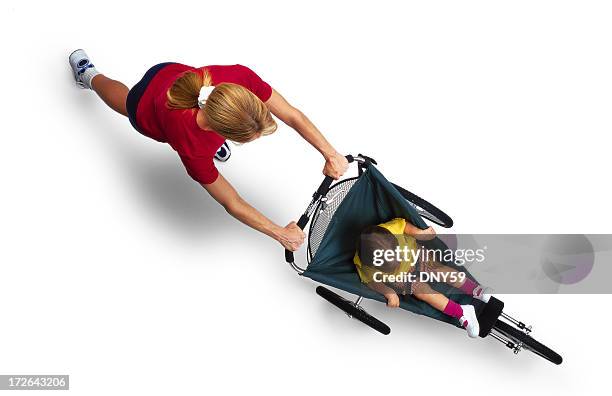 mother pushing child in jogger - buggy stock pictures, royalty-free photos & images