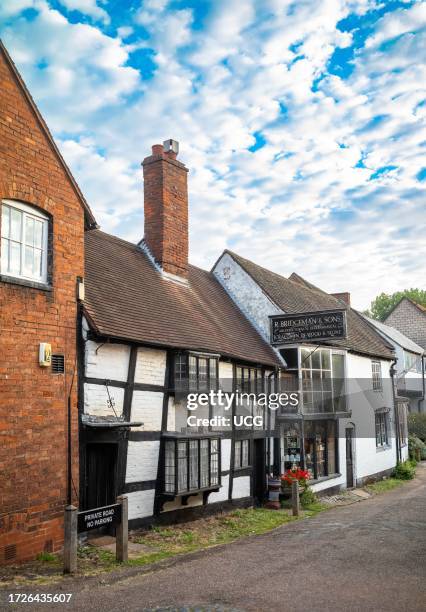 An ancient timber framed building with a tall brick chimney in the centre of Lichfield a beautiful ancient and historic city in Satffordshire, UK.