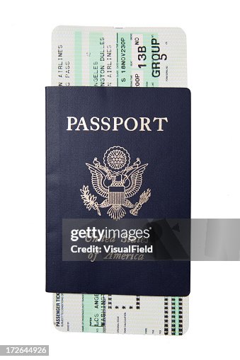 Blue passport with a white and green boarding pass Blue passport with a white and green boarding pass